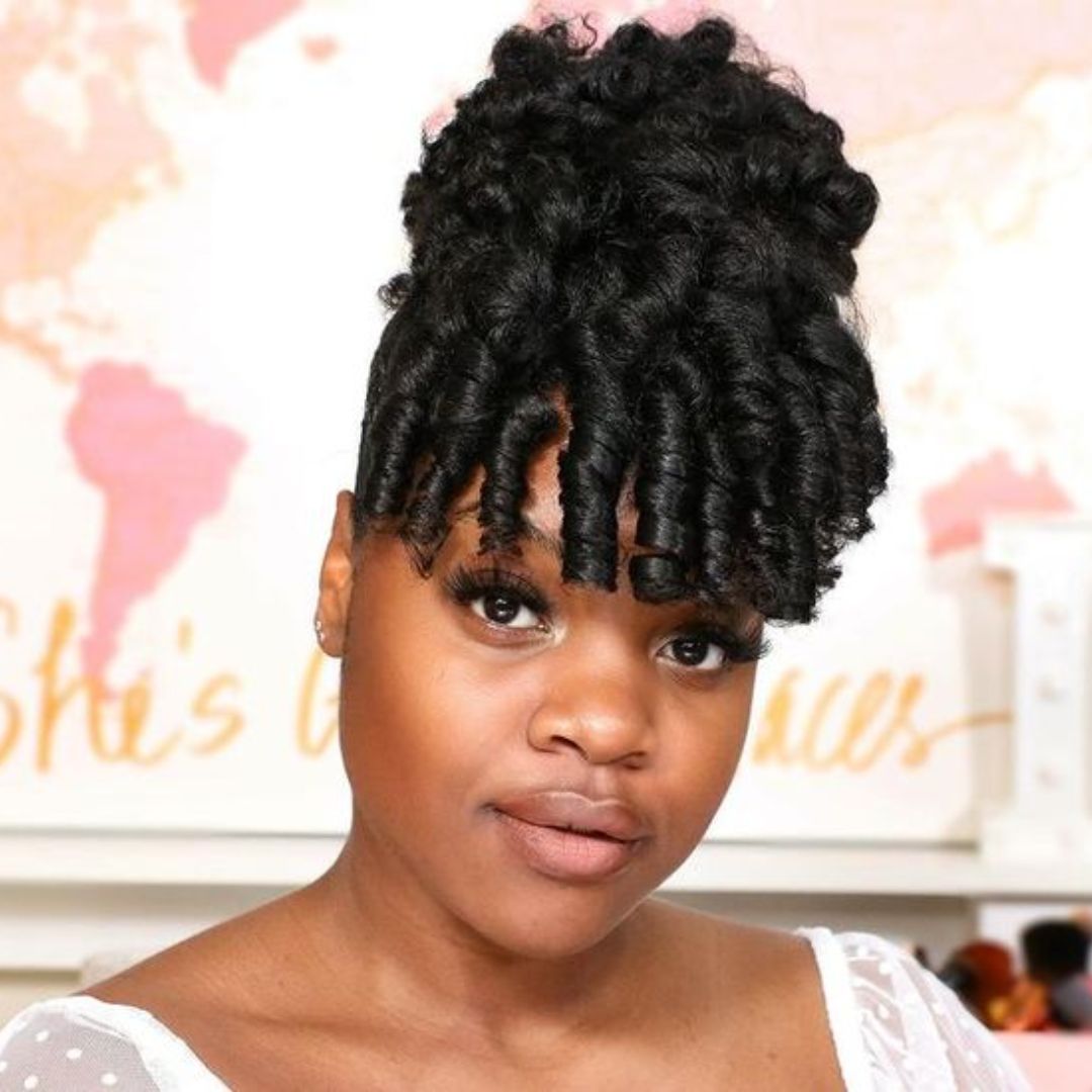 bun hairstyle with curly bangs