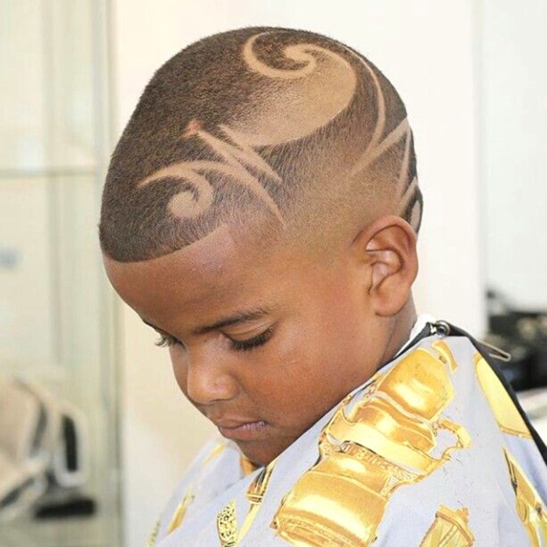 low haircut with shaved design on black kids