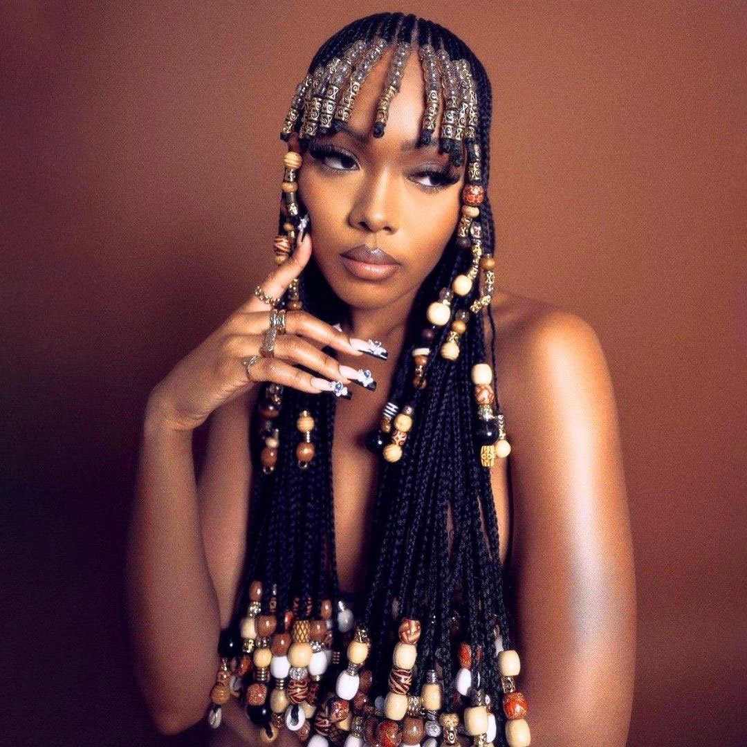 waist length braids witj beaded bangs on black women
