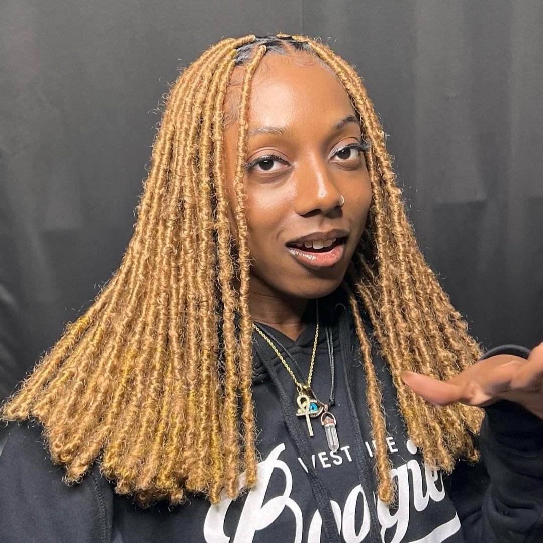 brown soft locs hairstyle on black women