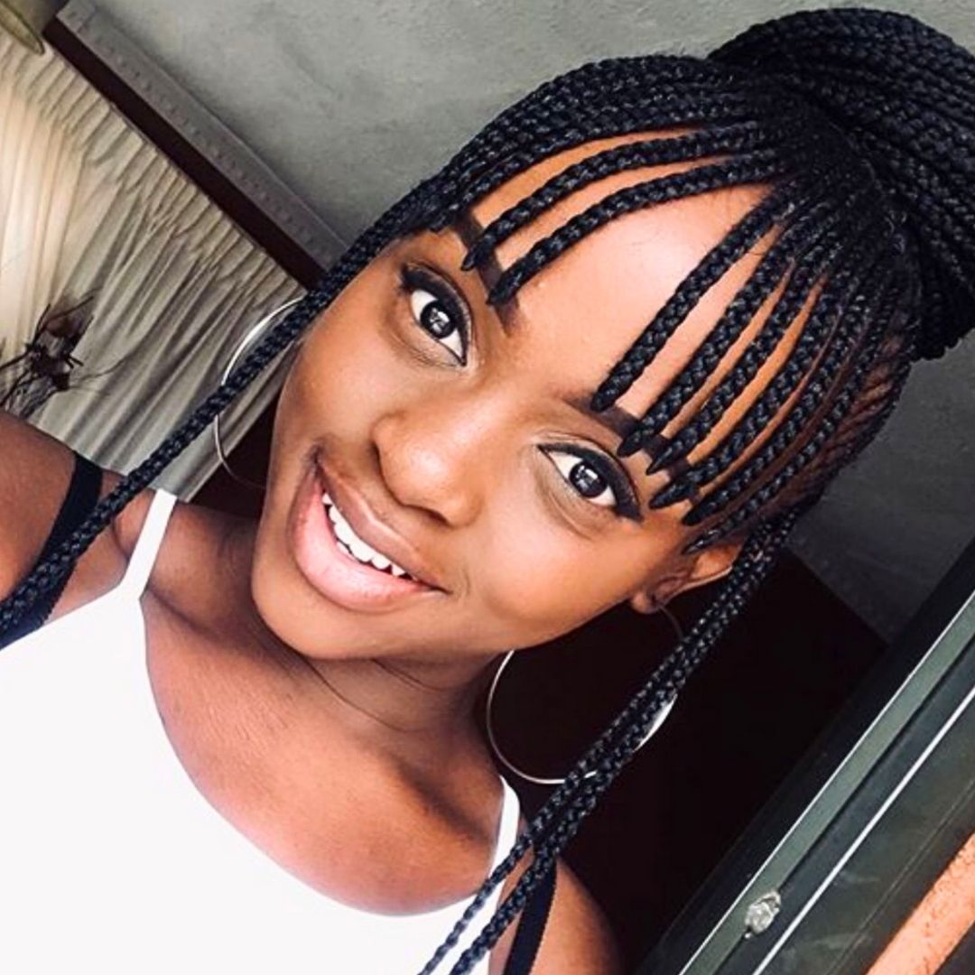 updo hairstyle with knotless full bangs on black women