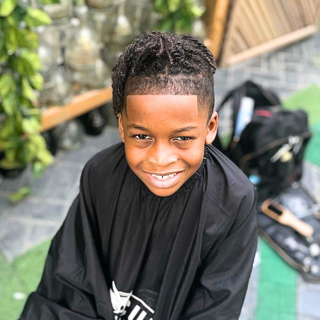 Low fade hairstyles with two strand twists on black boys