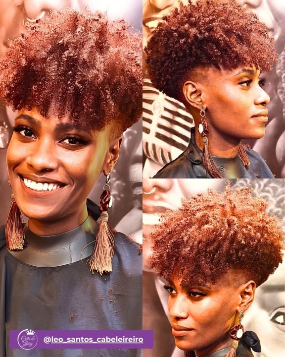 Natural coily afro dyed in rich auburn tones on top, contrasted with sharp, cleanly faded sides and neat edges.