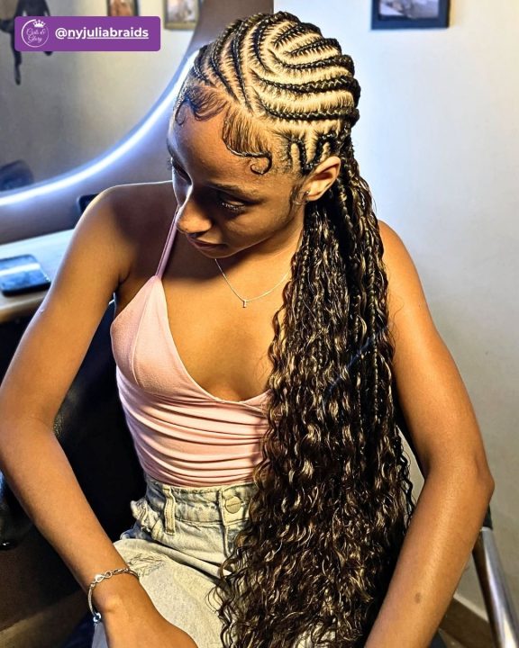 Boho-style feed-in lemonade braids with loose curls and neatly laid edges.