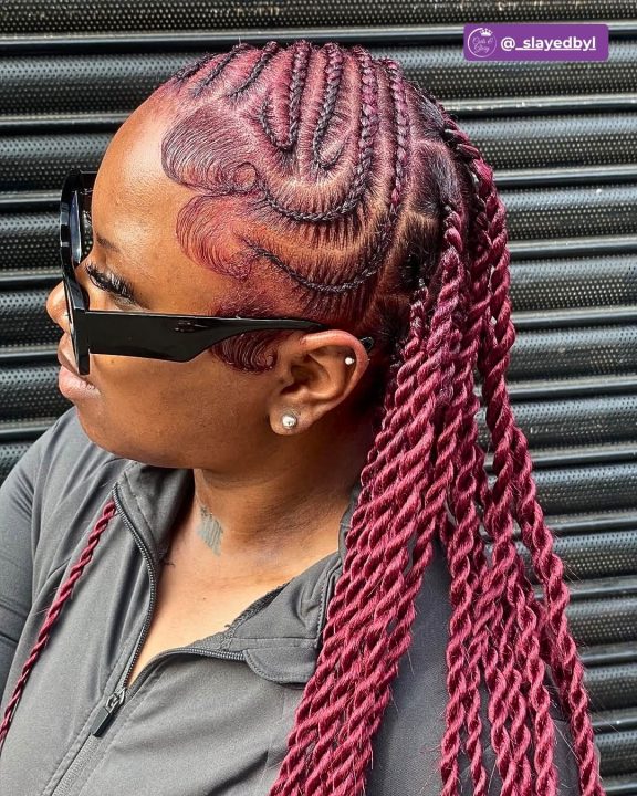 Burgundy-colored Senegalese twists braided in a classic side-swept lemonade style.