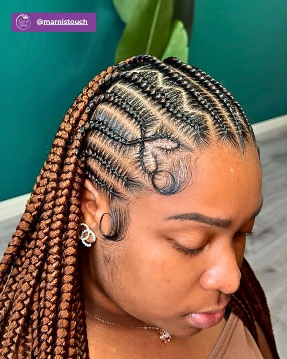 Copper brown island twists braided across the head in a side-swept lemonade style.