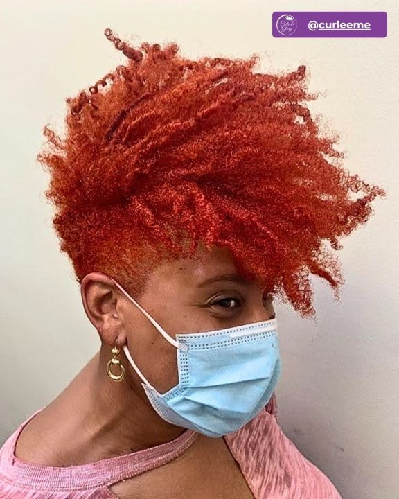 Copper coiled frohawk haircut featuring clean tapered sides.