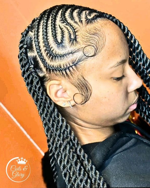 Jet black flat-twists braided in a freestyle, side-swept lemonade pattern.