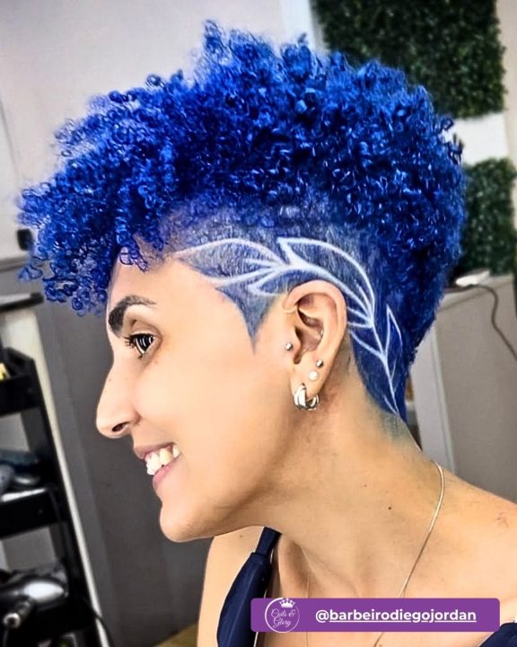 Vibrant royal blue ringlet taper cut for women featuring a leaf outline razor design.